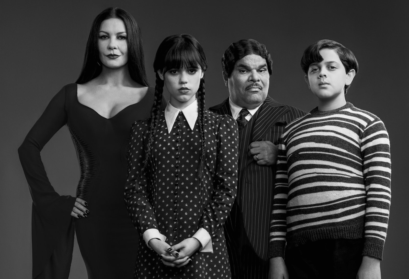 Wednesday. (L to R) Catherine Zeta-Jones as Morticia Adams, Jenna Ortega as Wednesday Addams, Luis Guzma?n as Gomez Addams, Issac Ordonez as Pugsley Addams in Wednesday. Cr. Courtesy of Netflix © 2022